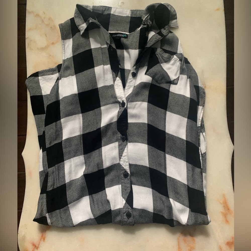 I am selling a cute sleeveless black and white button down checkered dress.